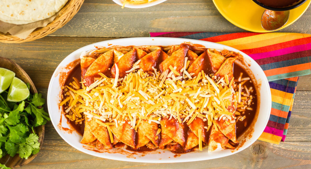 Chicken Enchiladas on a table with other Hispanic food